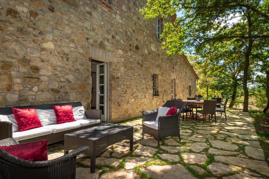 d'une terrasse avec un canapé, des chaises et une table. dans l'établissement Villa Lucarella with pool, Air Con - San Casciano dei Bagni, à San Casciano dei Bagni