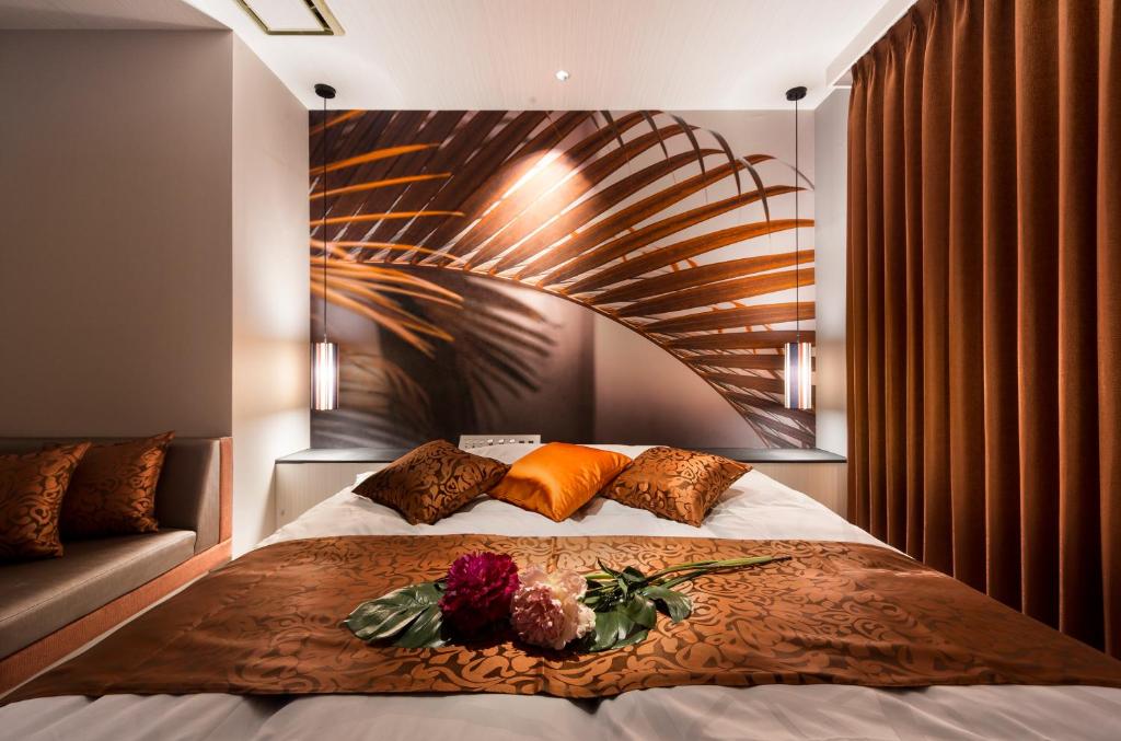 - une chambre avec un grand lit fleuri dans l'établissement HOTEL K's MINE, à Toyota