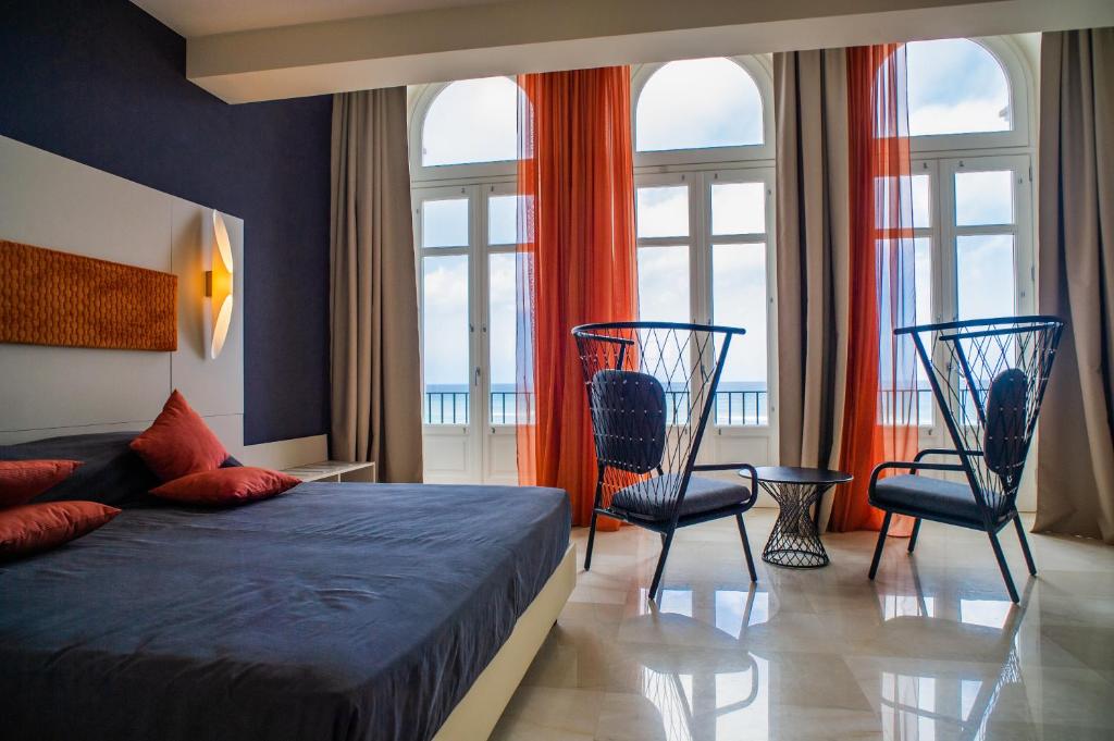 - une chambre avec un lit, 2 chaises et des fenêtres dans l'établissement Central Gallery Rooms- Palazzo D'Ali' Staiti XIX, à Trapani 144 autres photos