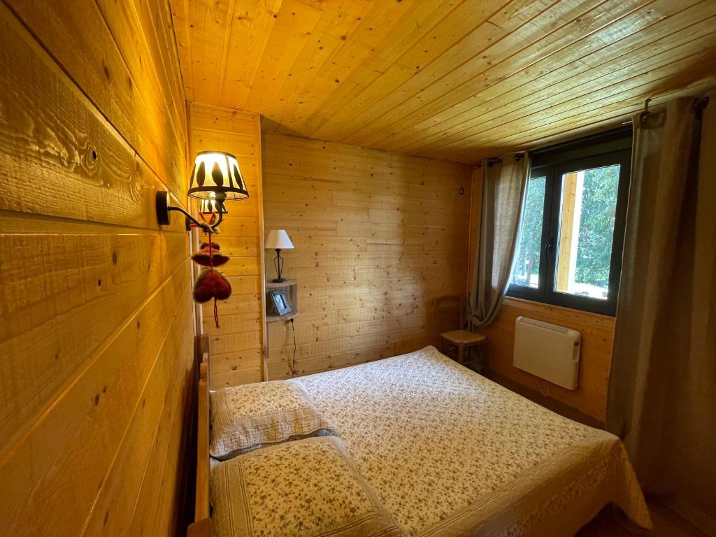 Cette petite chambre en bois comprend un lit. dans l'établissement Les Silènes pyrènes 2000 Meublé touristique 4 Etoiles, à Bolquère-Pyrénées 2000