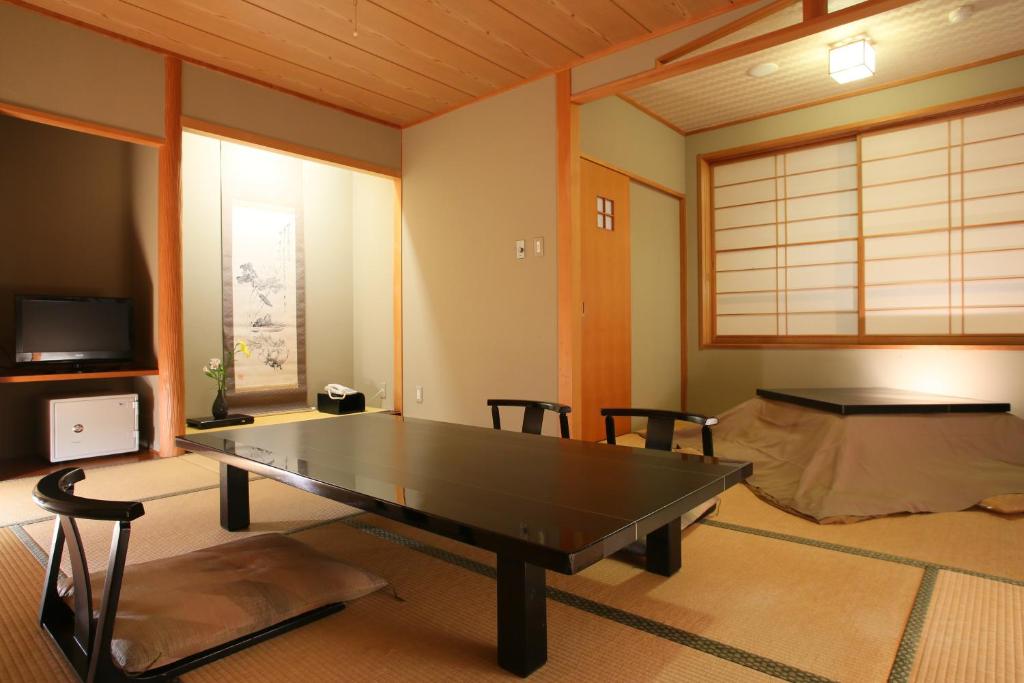 - une table de ping-pong dans une chambre avec un lit dans l'établissement Ichinoyu Katei, à Yamanouchi