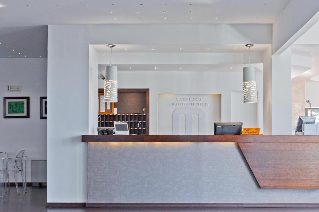 - un hall avec un comptoir de réception et des chaises dans l'établissement Mediterranea Residence, à Salerne
