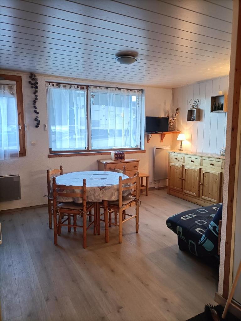 une cuisine avec une table et des chaises dans une pièce dans l'établissement Appartement 5 pers Plagne village, à La Plagne 7 autres photos