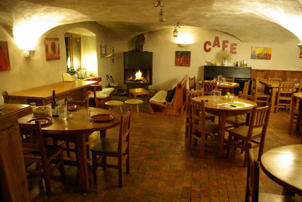 un restaurant avec des tables et des chaises et une cheminée dans l'établissement La Baïta Du Loup, à Saint-Véran