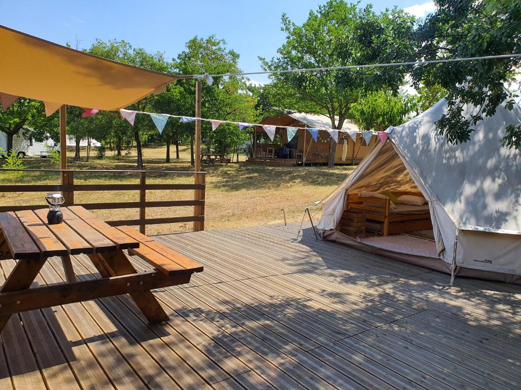 - une tente et une table de pique-nique sur une terrasse en bois dans l'établissement Le Mas Cauvy, à Saint-Christol-lès-Alès