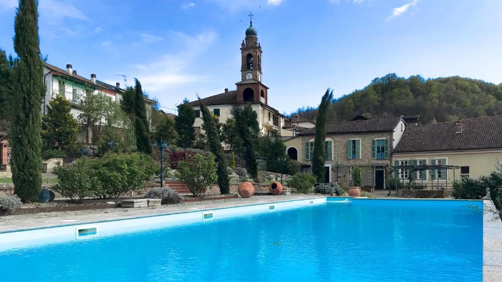 une grande piscine bleue devant un immeuble dans l'établissement Villa La Romantica 14, Emma Villas, à Grognardo