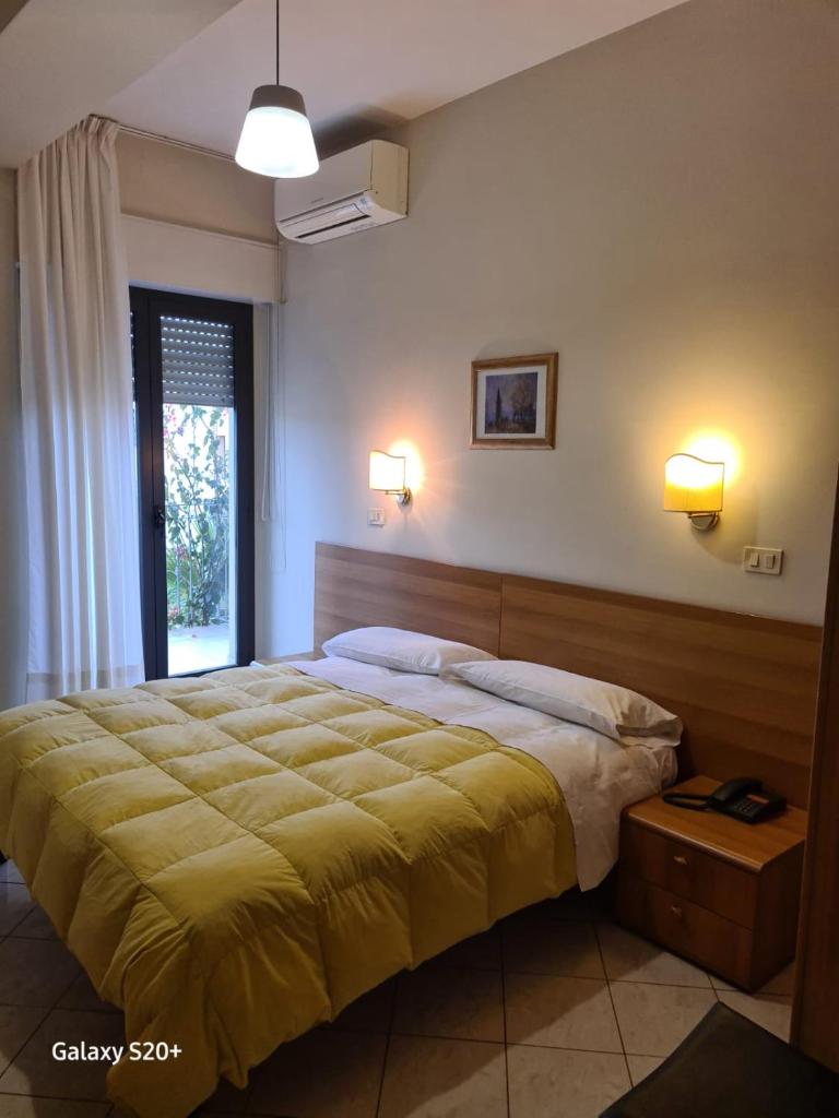 une chambre avec un grand lit et une fenêtre dans l'établissement Hotel Lido, à Vasto