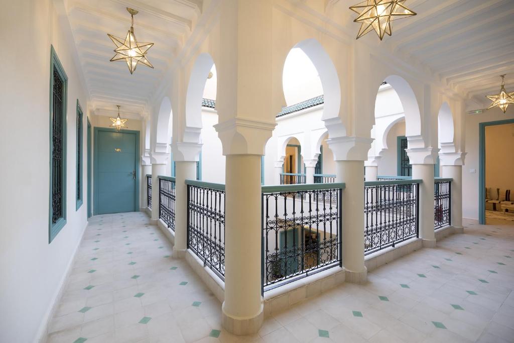 un couloir d'un bâtiment avec colonnes et plafonds dans l'établissement Riad l'Esprit des Patios & Spa, à Marrakech 37 autres photos