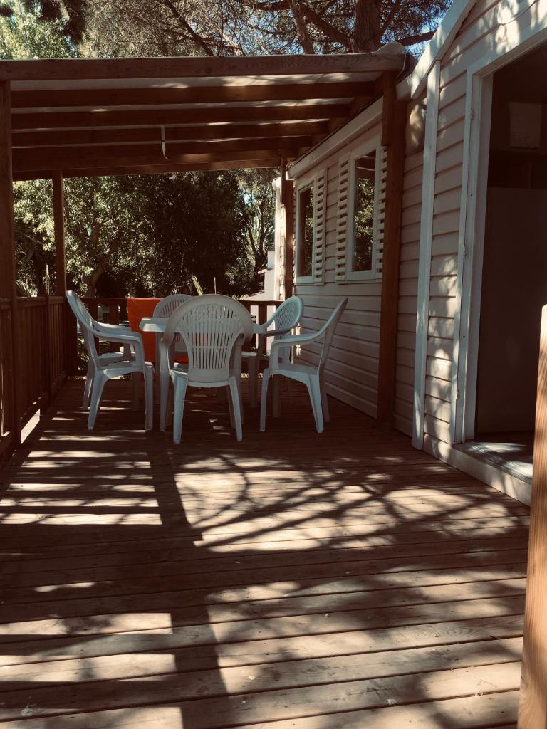 une terrasse avec une table et des chaises dans une maison dans l'établissement parc des 7 fonts, à Agde