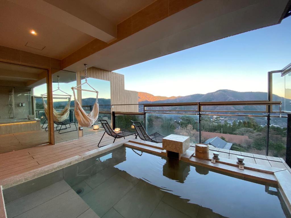 une maison avec une piscine et une vue sur les montagnes dans l'établissement Gen Hakone Gora, à Hakone