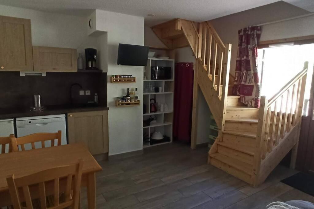une cuisine avec un escalier menant à un salon dans l'établissement Appartement duplex au pied des pistes, à Saint-Étienne-en-Dévoluy