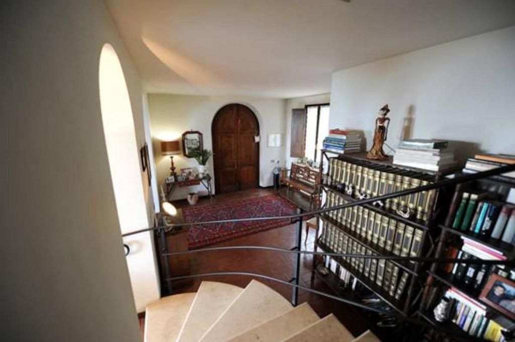 Cette chambre est dotée d'un escalier avec des livres et une porte. dans l'établissement Il Casale, à Formia