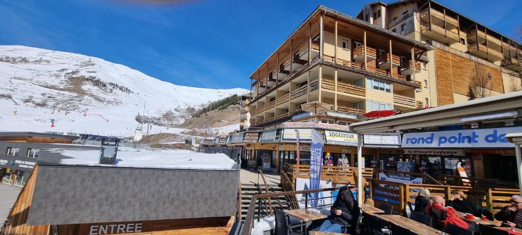une station de ski avec un bâtiment et une montagne dans l'établissement Studio 57, à Orcières