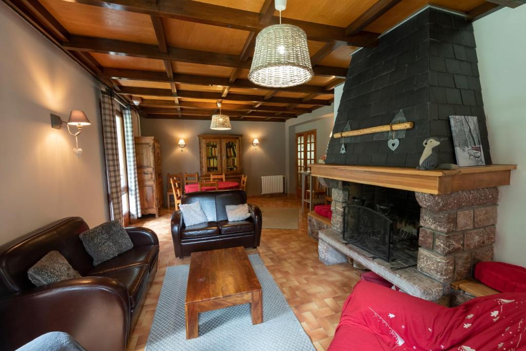 un salon avec une cheminée et un canapé dans l'établissement Logis Hôtel Spa la Cascade, à Ceillac