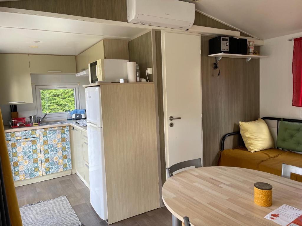 - une petite cuisine et une table dans une caravane dans l'établissement Bungalow climatisé dans un bel écrin de nature, à Saint-Chéron