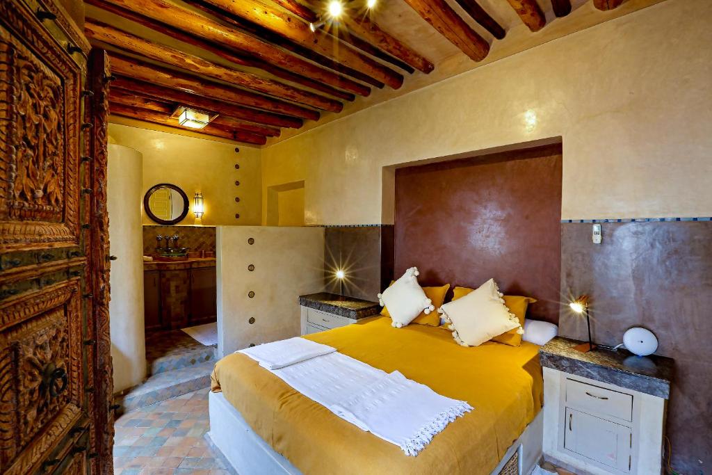 - une chambre avec un grand lit jaune dans l'établissement Riad 92 - Architect's Riad in the Exclusive Dar El Bacha, à Marrakech