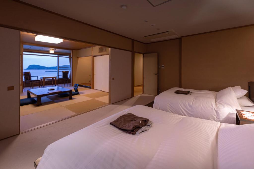 une chambre avec deux lits et une vue sur l'océan dans l'établissement IKI RETREAT by Onko Chishin, à Iki 37 autres photos