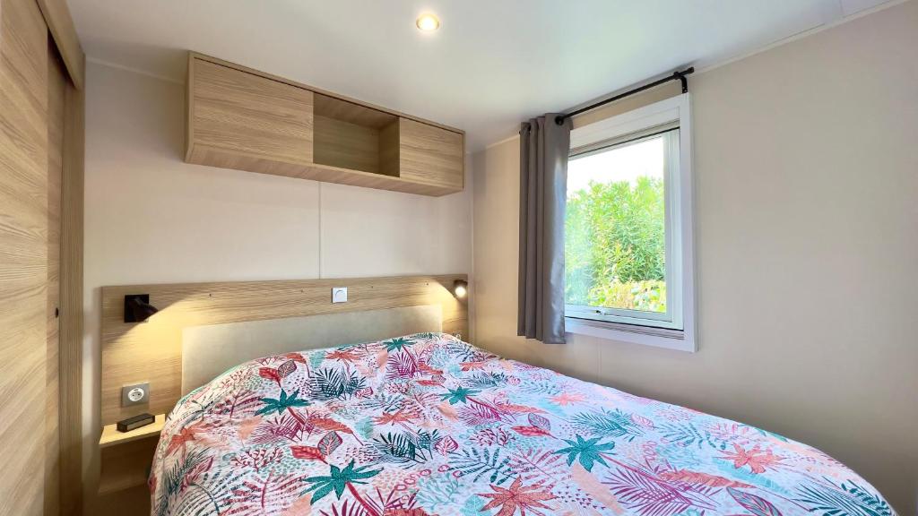une petite chambre avec un lit et une fenêtre dans l'établissement L'incontournable Tout Confort Camping Siblu, à Fréjus