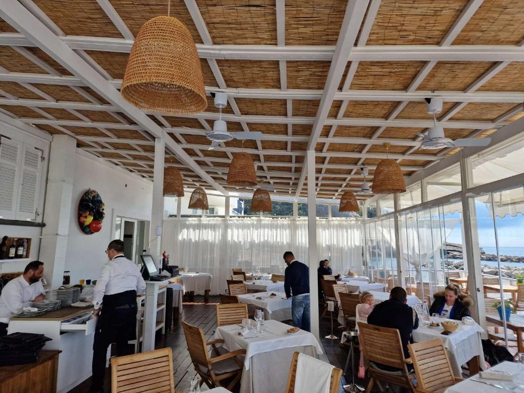 un restaurant avec des personnes assises dans une salle dans l'établissement Roccobarocco Boutique Hotel, à Ischia