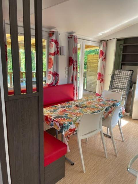 une salle à manger avec une table et deux chaises dans l'établissement Camping Le Ruisseau, à Saint-André-de-Seignanx