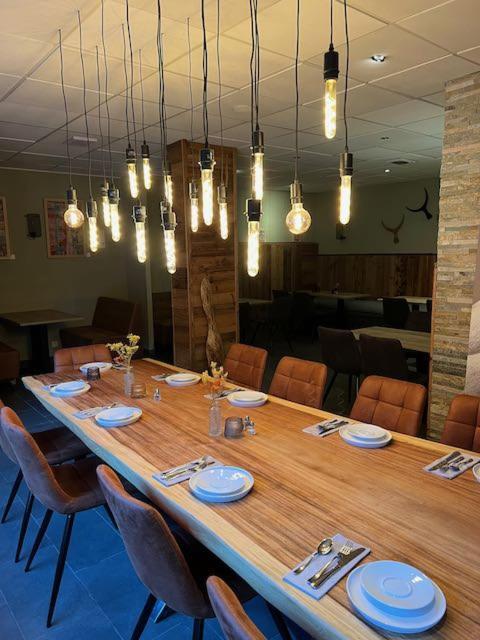 - une grande table en bois dans un restaurant avec des chaises dans l'établissement Large premium alpine apartment for 4 to 8 people, à Vallorcine