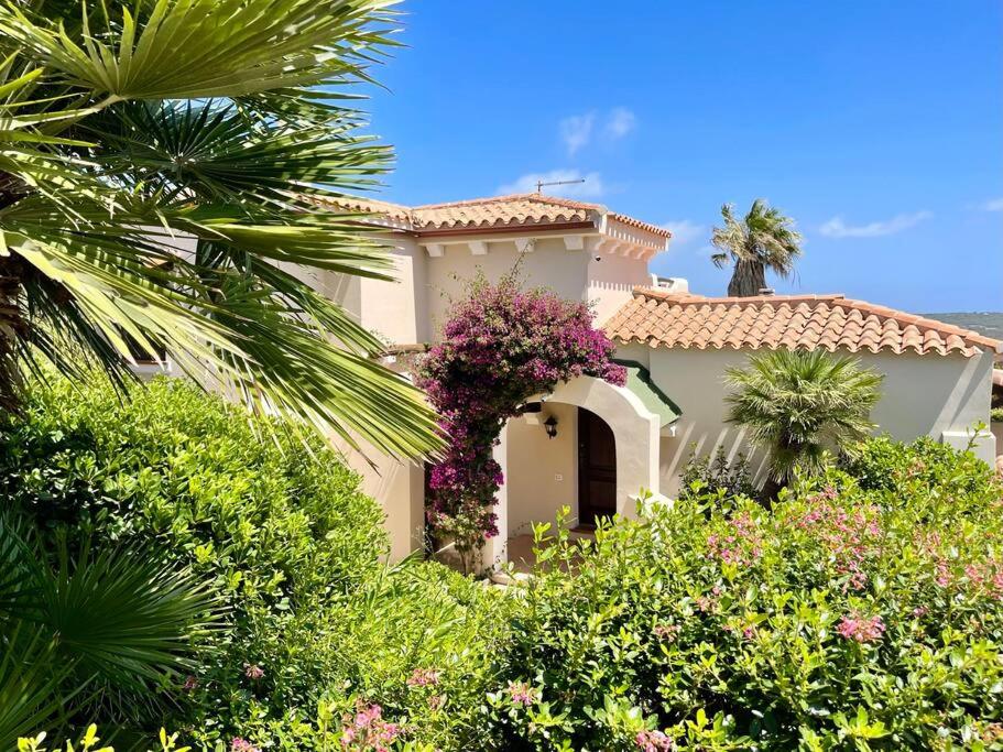 une maison avec un bouquet de fleurs devant dans l'établissement Villa Hibiscus Stintino, à Stintino