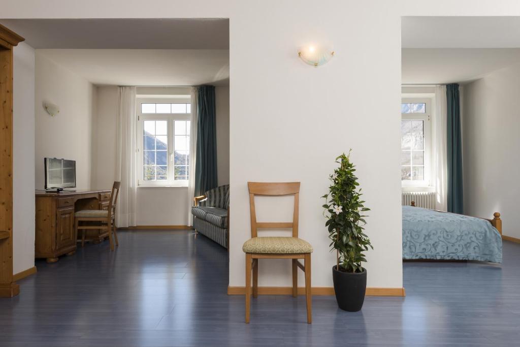 - une chambre avec un lit, une chaise et une plante dans l'établissement Grand Hotel Molveno, à Molveno 57 autres photos