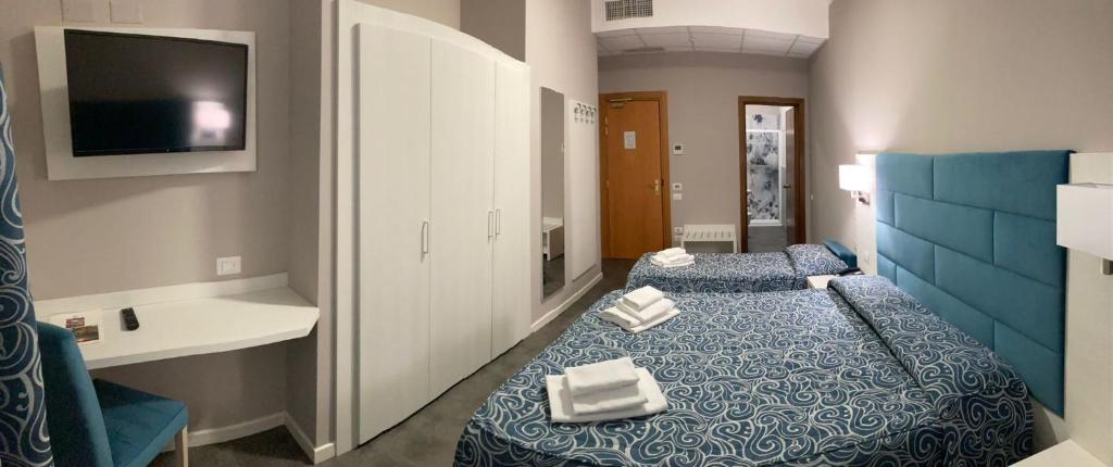 une chambre d'hôtel avec deux lits et une télévision dans l'établissement Albergo MP Noli, à Noli 51 autres photos