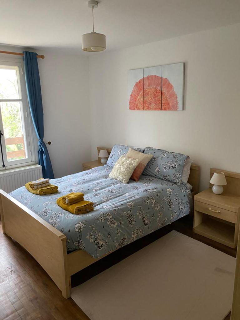une chambre avec un lit avec une couette bleue dans l'établissement Les Roseries Boutique Gite, à Clussais-la-Pommeraie