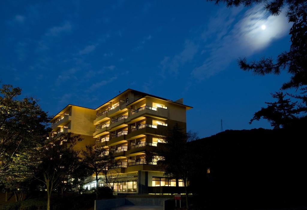 un bâtiment la nuit avec la lune dans le ciel dans l'établissement Saiou no Miya, à Ise
