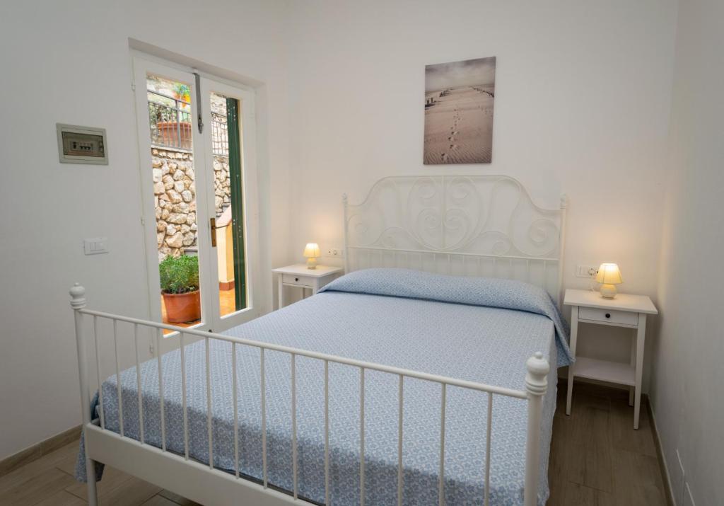 - une chambre avec un lit blanc et 2 tables de chevet dans l'établissement Hotel Anna, à Fetovaia