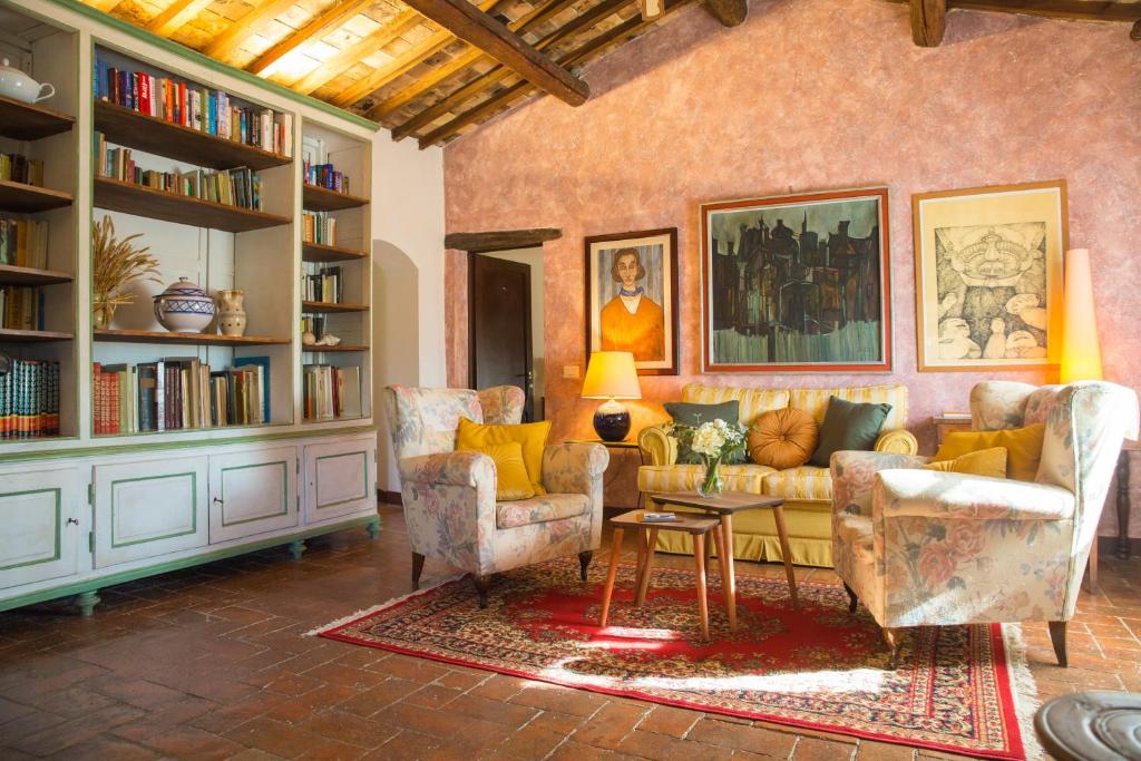 - un salon avec un canapé, des chaises et des étagères dans l'établissement Villa Giorgia, à San Gimignano