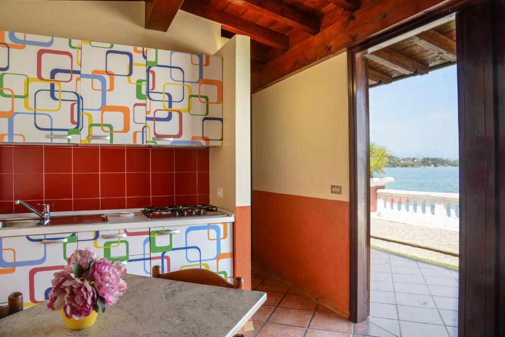une cuisine avec une cuisinière et un comptoir dans l'établissement VILLA GARUTI VILLAGE, à Padenghe sul Garda