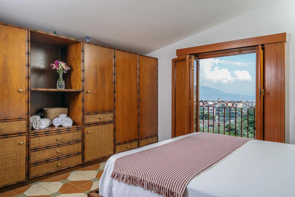 une chambre avec un lit et une grande fenêtre dans l'établissement Villa Aurora, à Vico Equense