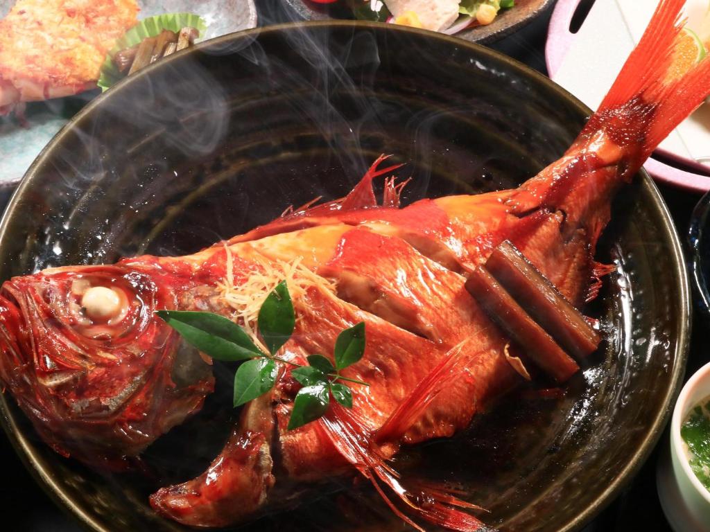 une assiette de nourriture avec un poulet sur une table dans l'établissement ふかべ, à Itō
