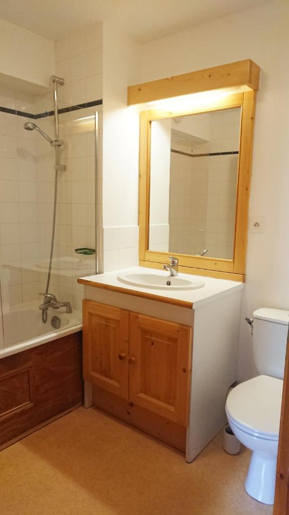une salle de bain avec un lavabo, des toilettes et un miroir dans l'établissement Résidence Valmonts A, Les Ménuires, appartement 2 pièces, aux Menuires