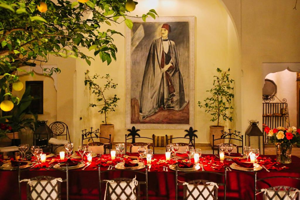 une salle à manger avec une table et des nappes rouges dans l'établissement Riad du Ciel Marrakech, à Marrakech