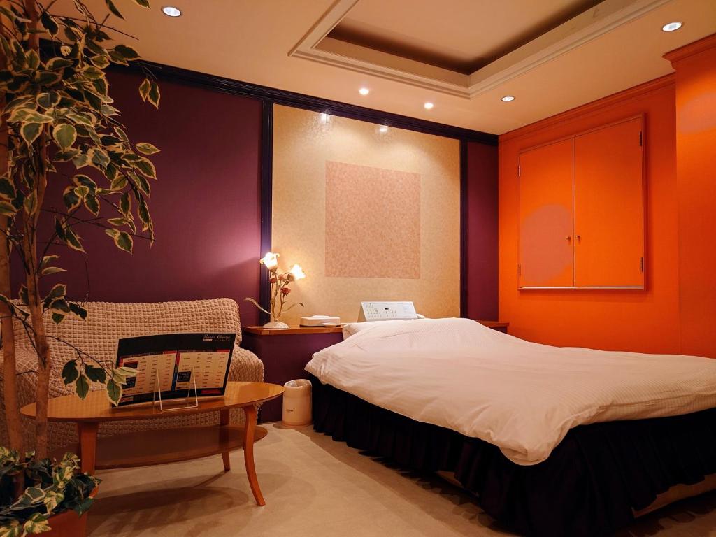 une chambre avec un lit, une table et une chaise dans l'établissement hotel due, à Ōgaki