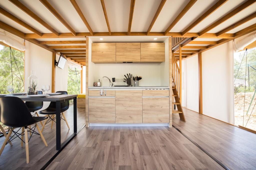 une cuisine et une salle à manger avec une table et des chaises dans l'établissement Le lodge de la Catouniere, à Castillon-du-Gard 9 autres photos