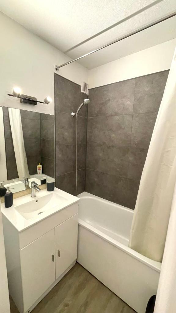 une salle de bain avec une baignoire, un lavabo et une douche dans l'établissement Appartement Puy-Saint-Vincent, à Puy-Saint-Vincent
