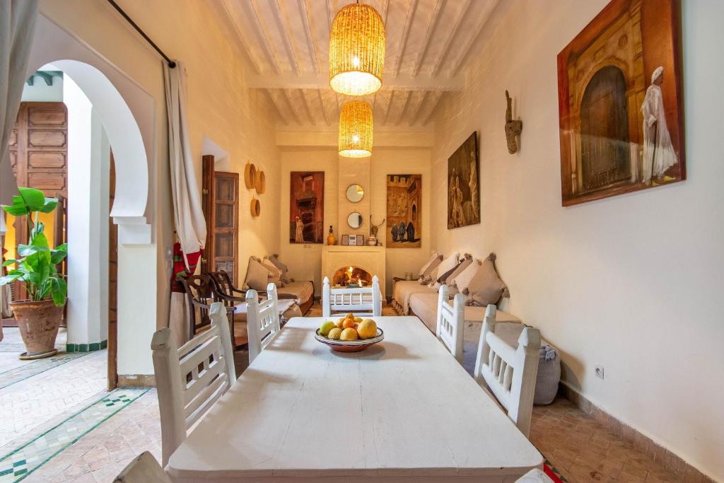 une salle à manger avec une table avec un bol de fruits dessus dans l'établissement Riad Dar Al Barakaa - EXCLUSIVE - Breakfast, à Marrakech