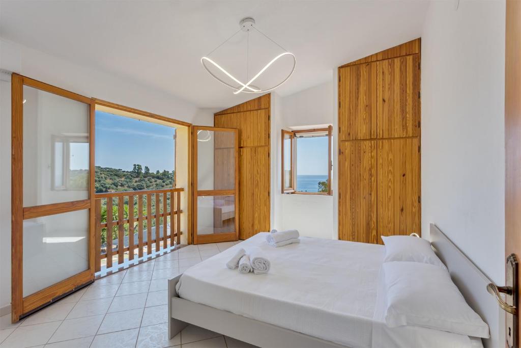 une chambre avec un lit et un balcon dans l'établissement Villa Perla Marina, à Tertenìa