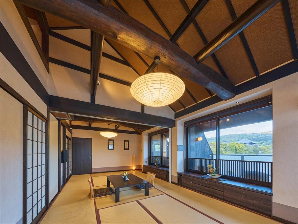 un salon avec une table et une grande fenêtre dans l'établissement Wakasa Annex, à Nara