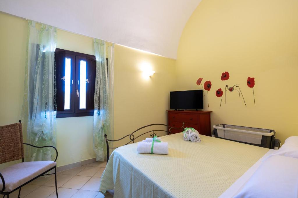 - une chambre avec un lit, une fenêtre et une télévision dans l'établissement Trullo nonna Pina, à San Michele Salentino