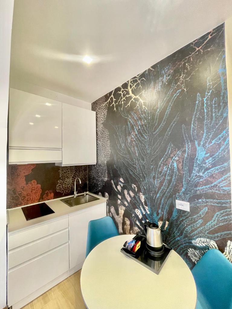 une cuisine avec une table et des chaises bleues dans l'établissement Hotel Tirreno, à Marina di Massa 78 autres photos