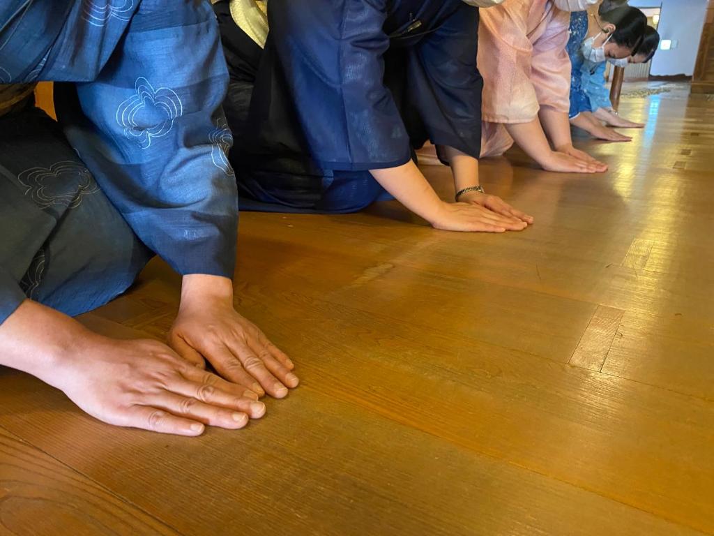 un groupe de personnes debout sur un plancher en bois dans l'établissement Wakamatsu Hot Spring Resort, à Hakodate 37 autres photos