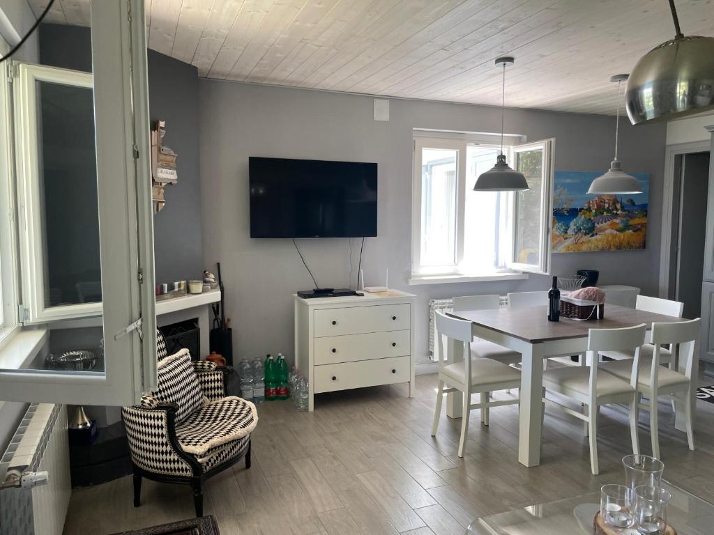 une salle à manger avec une table et des chaises et une télévision dans l'établissement Tenuta di Quaranta, à Amaroni