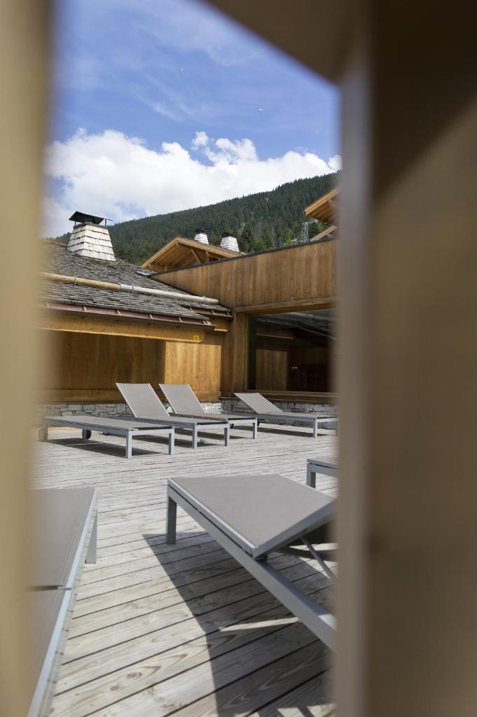 une rangée de bancs assis sur un pont dans l'établissement CGH Résidences & Spas Les Chalets de Jouvence, aux Carroz d'Arâches 28 autres photos