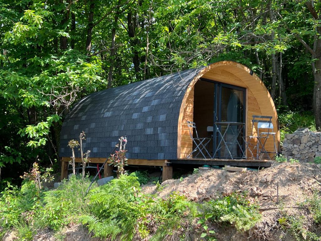 une petite maison en forme de dôme avec un toit noir dans l'établissement La Cabane enchantée, Mas Favières, à Notre-Dame-de-la-Rouvière