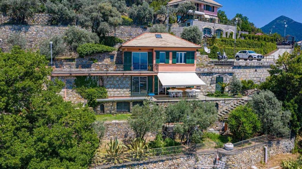 une maison au sommet d'une colline avec une voiture garée dans l'établissement Villa Pia Recco, à Recco